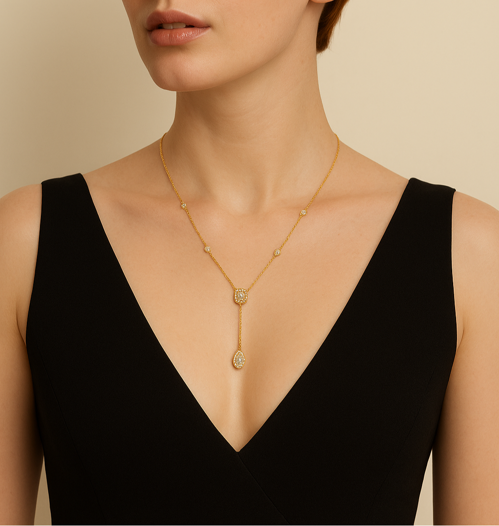 Woman wearing a gold necklace against a beige background