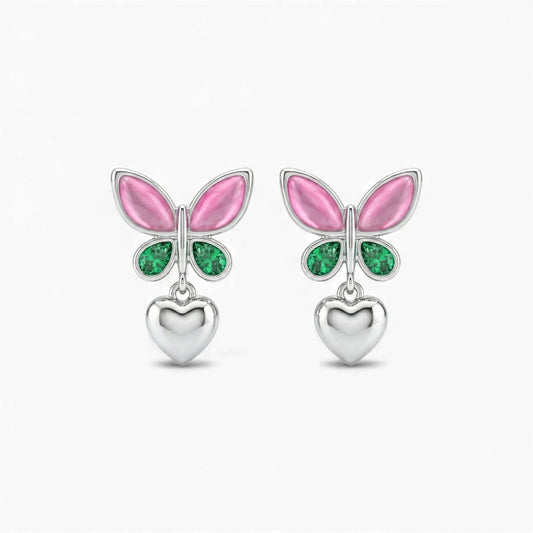 Butterfly-shaped earrings with pink wings and green gemstones on a white background