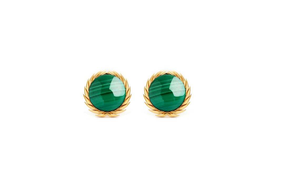 A pair of 18karat gold stud earrings with black onyx centers, surrounded by gold filigree designs.