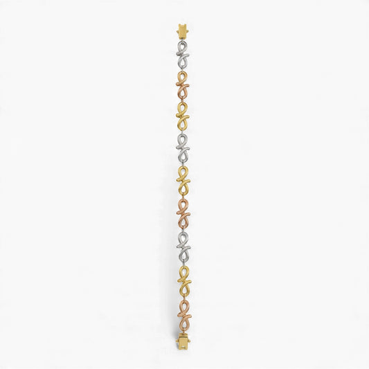 Three-strand bracelet with gold, silver, and rose gold links on a white background