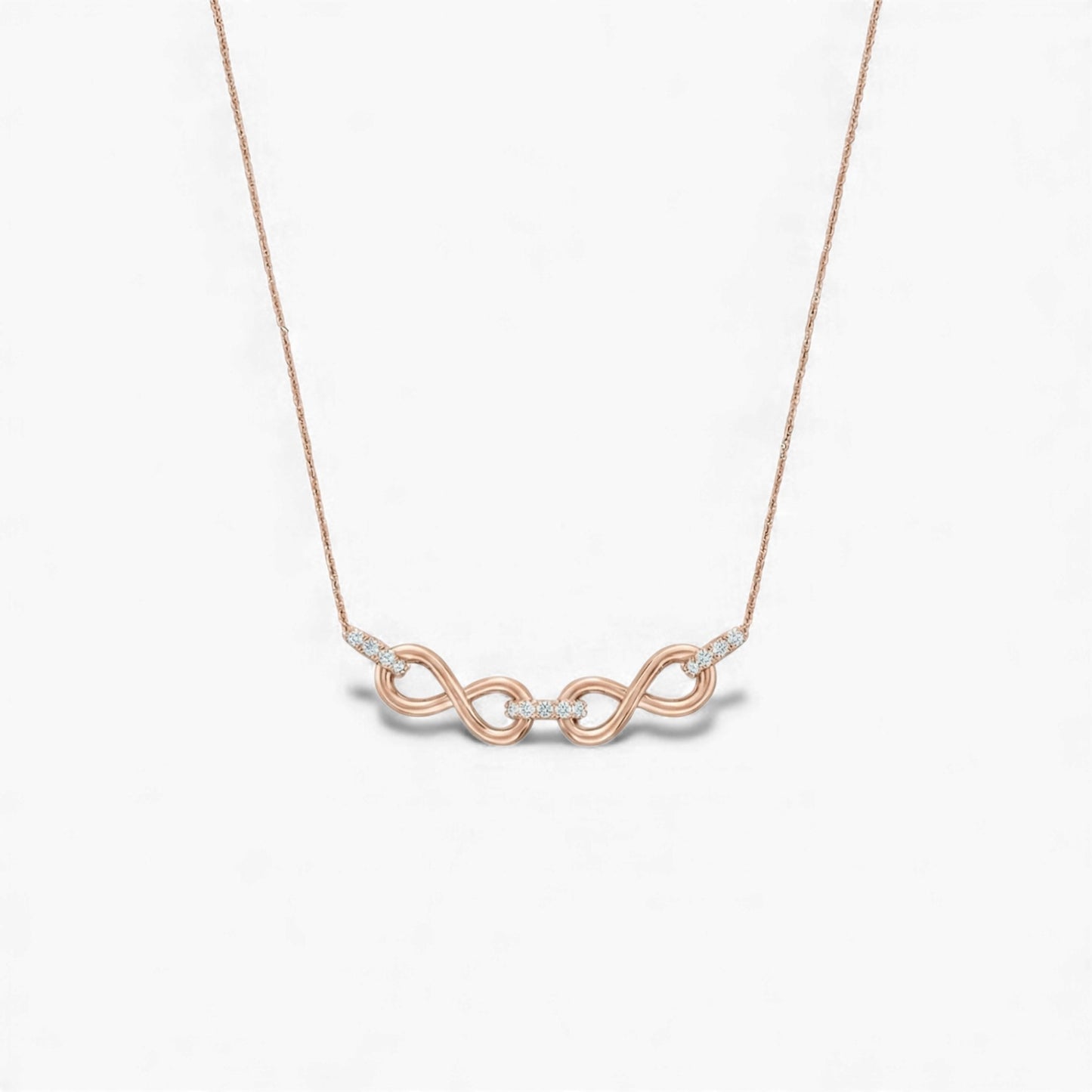Rose gold necklace with a unique pendant on a light gray background