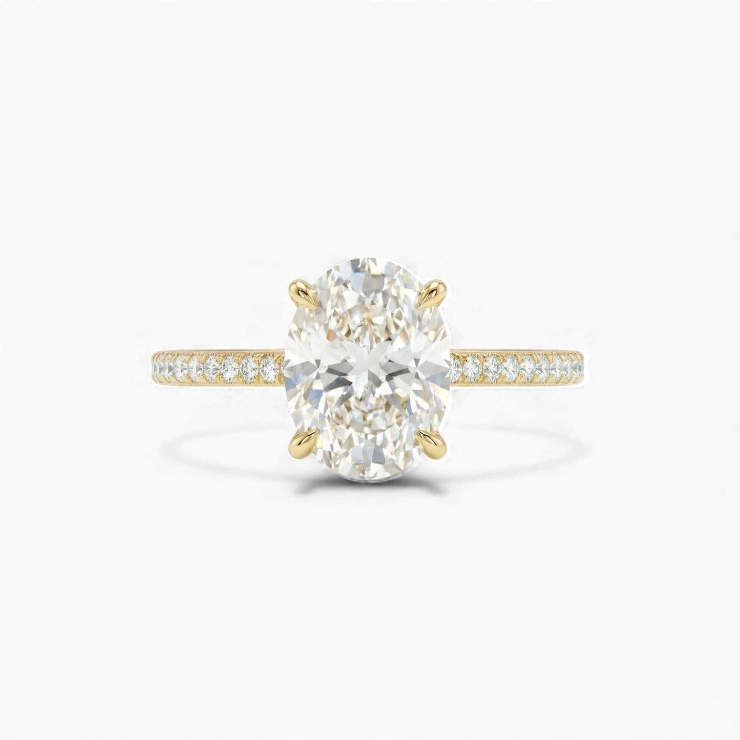 Gold ring with a large diamond and smaller diamonds on the band against a white background