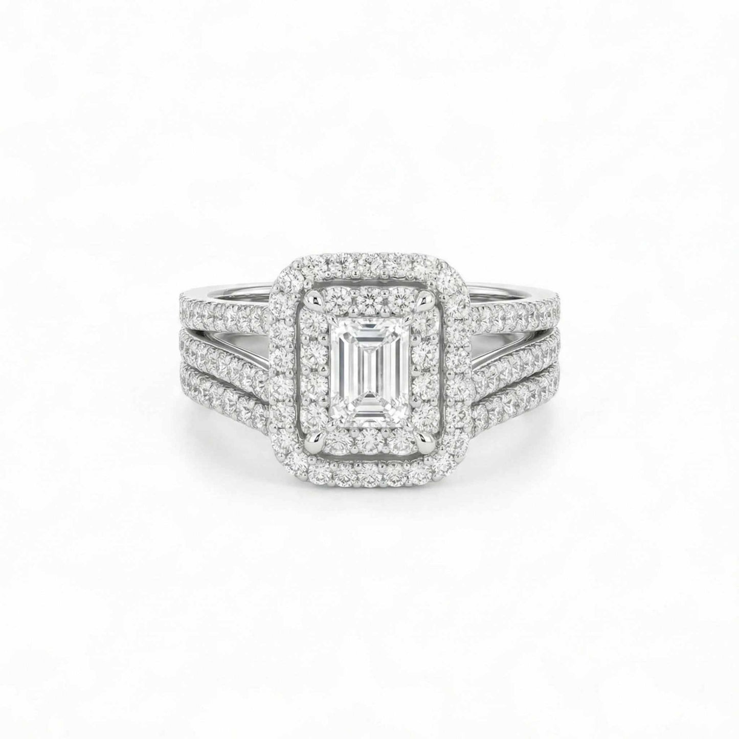 Diamond ring with emerald-cut center stone on a white background