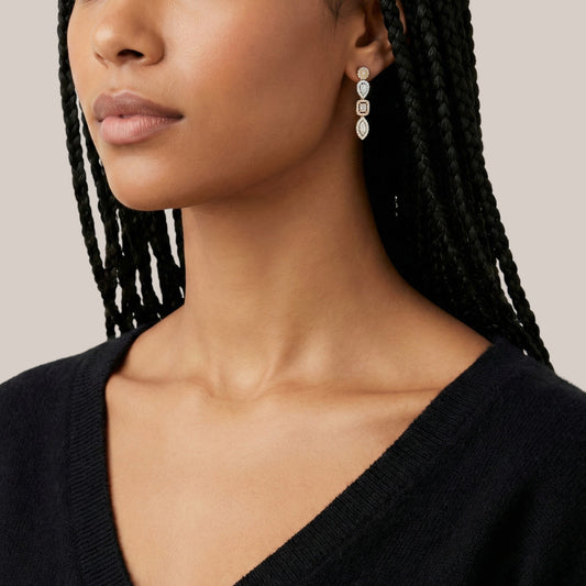 Close-up of a woman wearing a black top with a neutral background