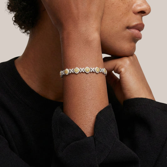 Close-up of a person wearing a bracelet with a neutral background