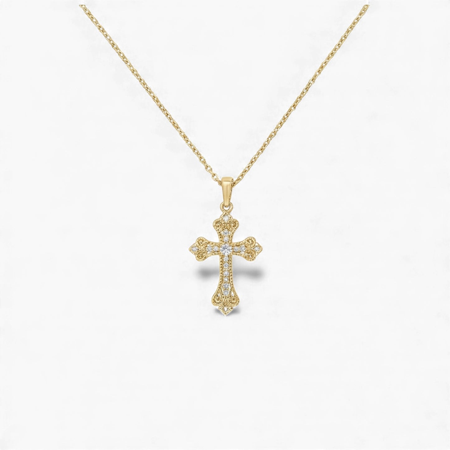 Gold cross pendant necklace on a white background
