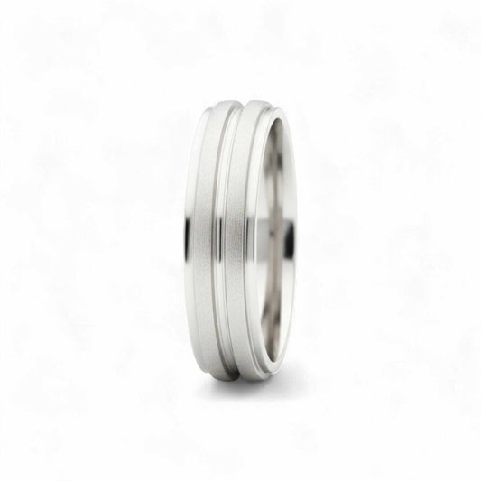 Silver ring with a textured band on a white background