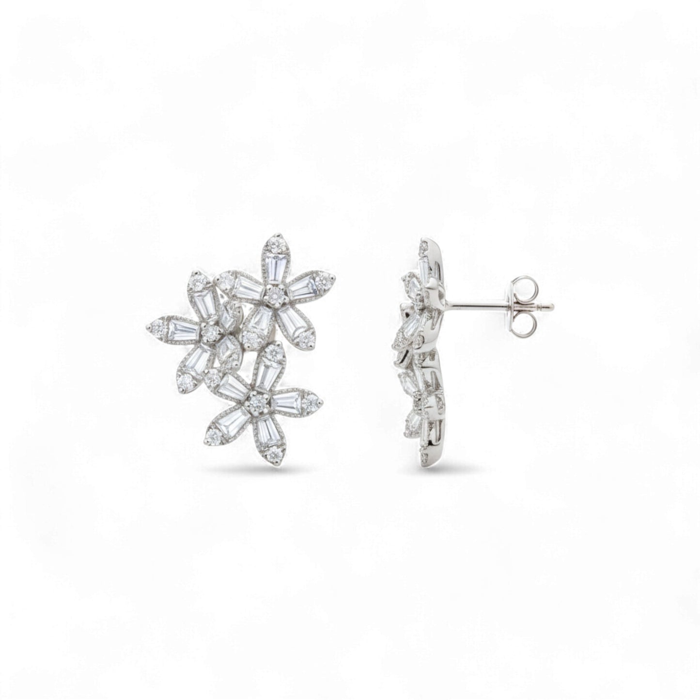 Pair of silver floral earrings on a white background