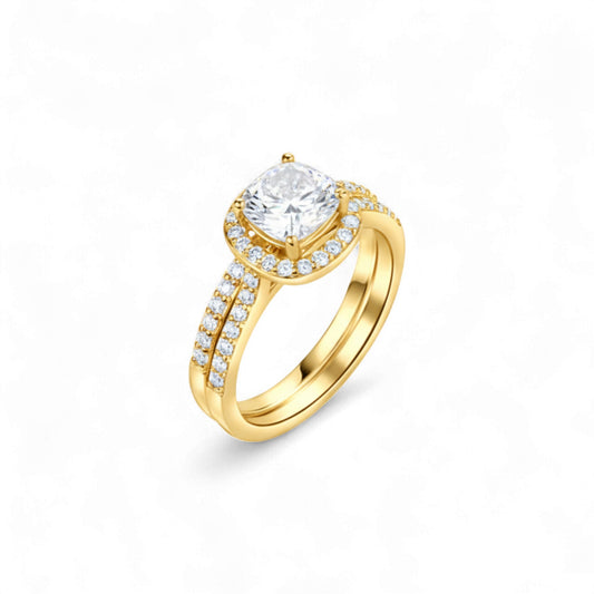 Gold ring with a large diamond and smaller diamonds on the band against a white background