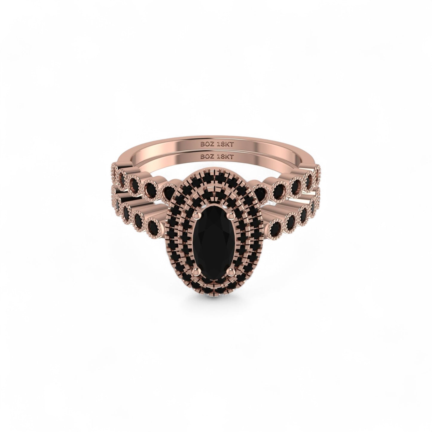 Rose gold ring with black gemstones on a white background