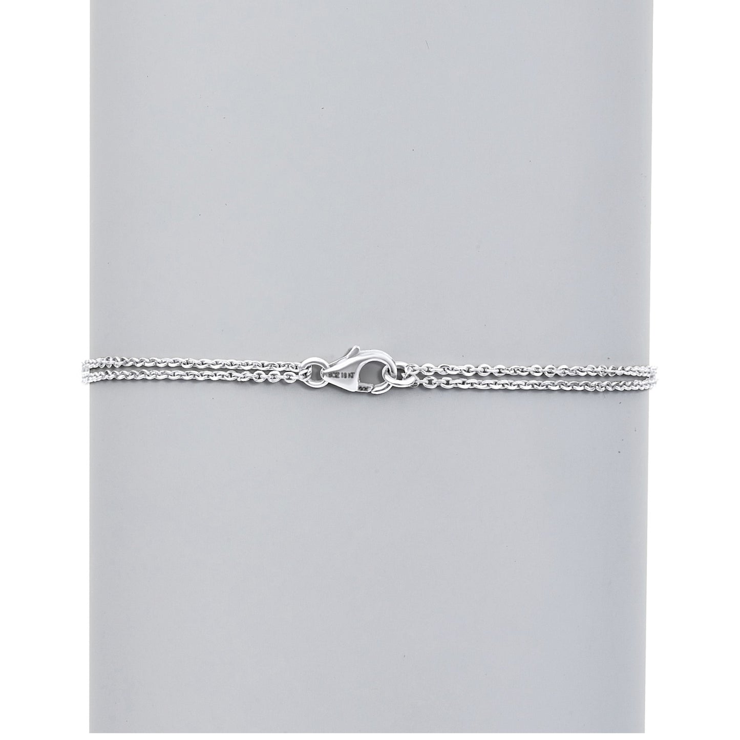 Silver chain bracelet on a light gray background