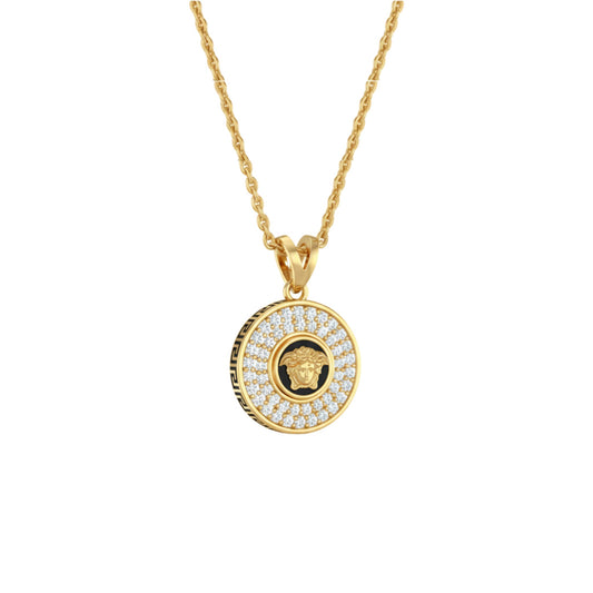 Gold necklace with a round pendant featuring a face design on a white background