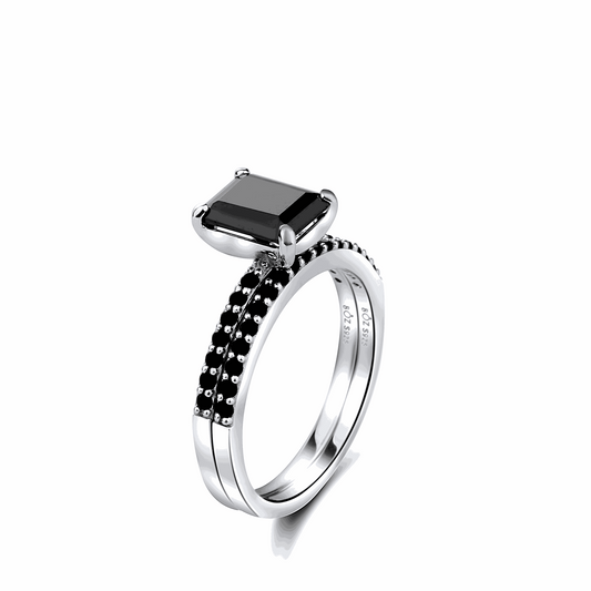 Silver ring with a black gemstone on a white background