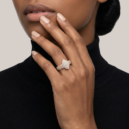 Hand wearing a diamond ring with a neutral background
