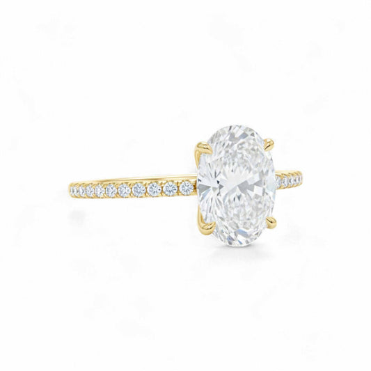 Gold ring with a large diamond and smaller diamonds on the band against a white background