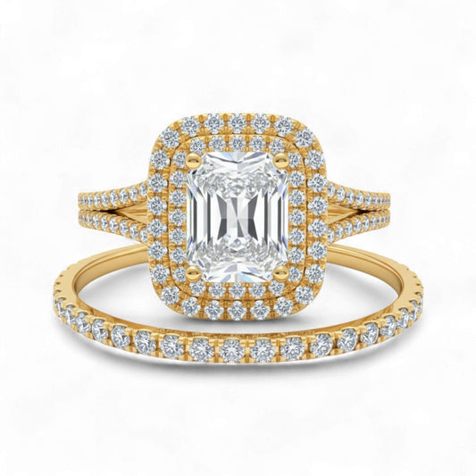 Gold ring with emerald-cut center stone and diamond halo on a white background