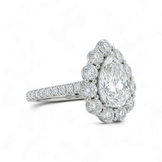Diamond ring with a pear-shaped center stone on a white background