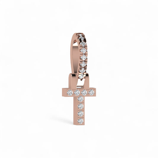 Rose gold cross-shaped earring with diamonds on a white background