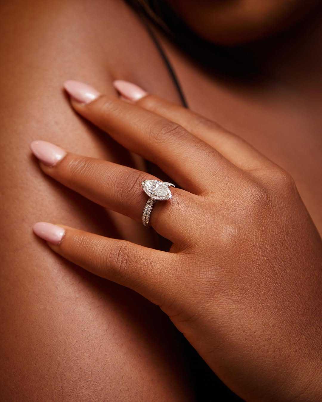 Classic Marquise Cut moissanite and diamond bride set in 18K gold on hand