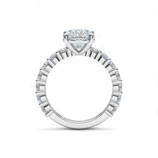 Diamond ring with a central gemstone and smaller stones on a white background