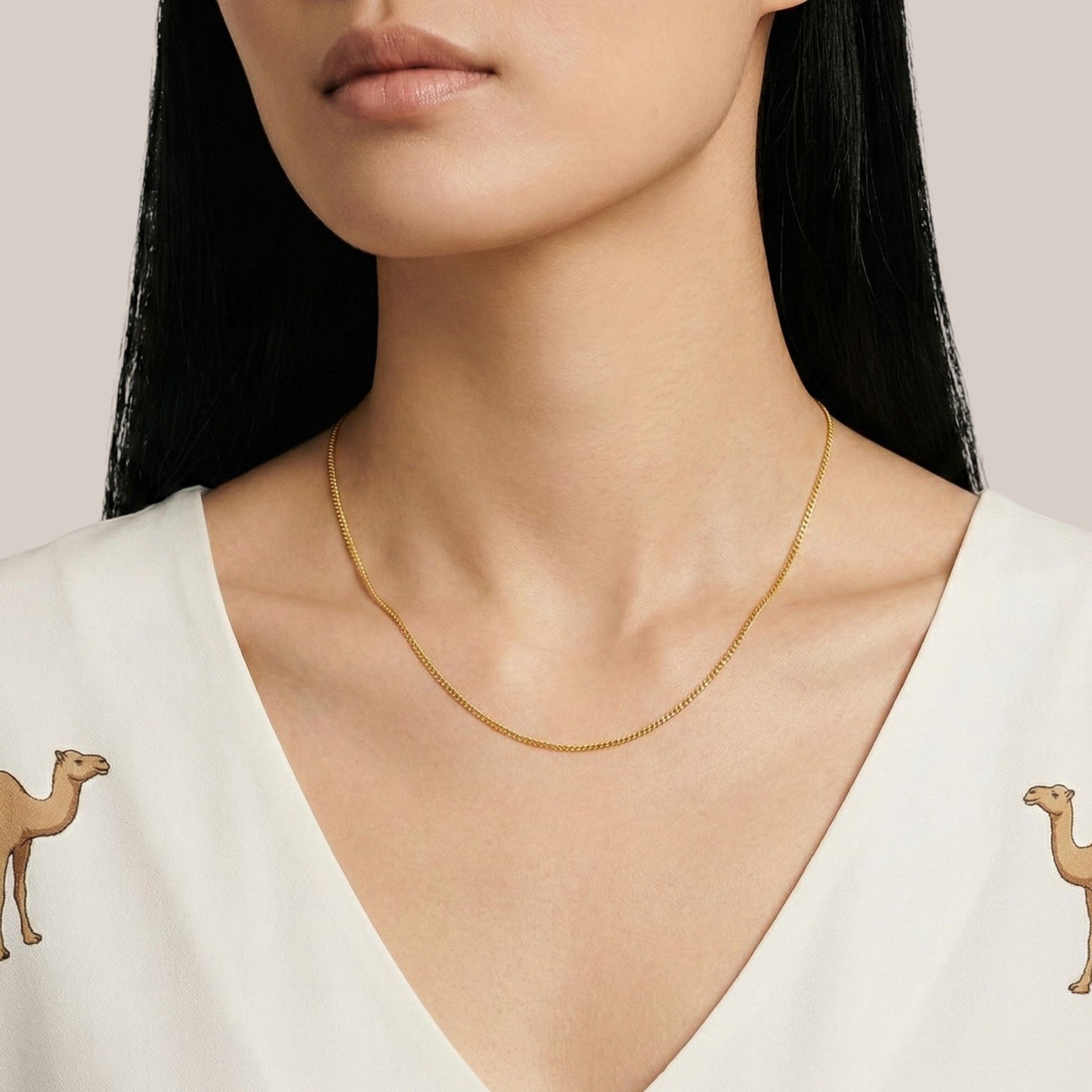 Gold necklace on a model with a white background