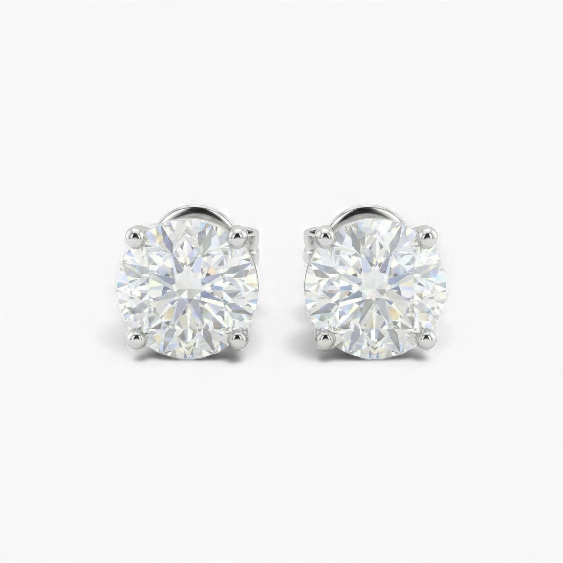 Pair of diamond stud earrings on a white background