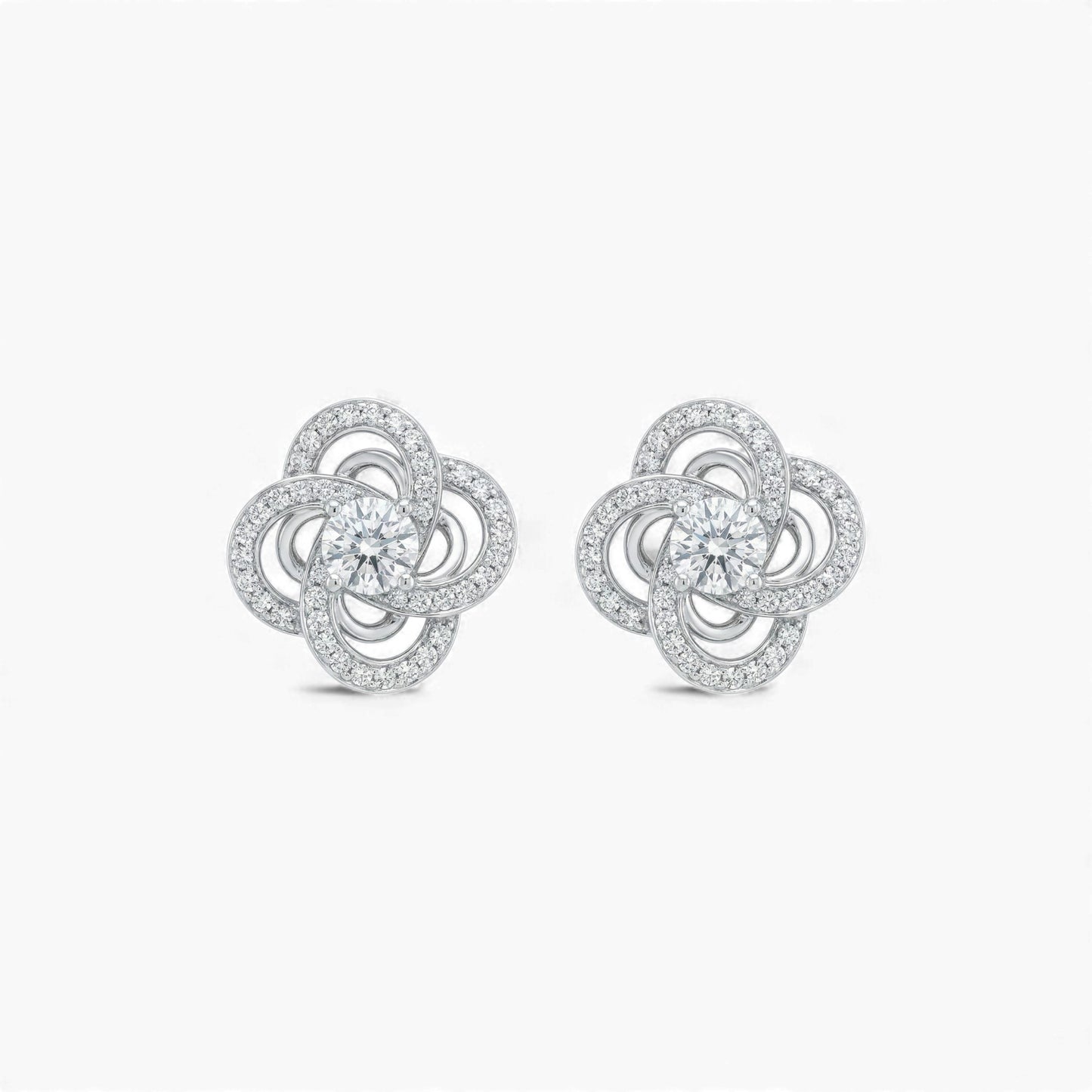 Pair of silver flower-shaped earrings on a white background