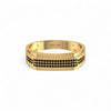 Gold ring with black diamond pattern on a white background