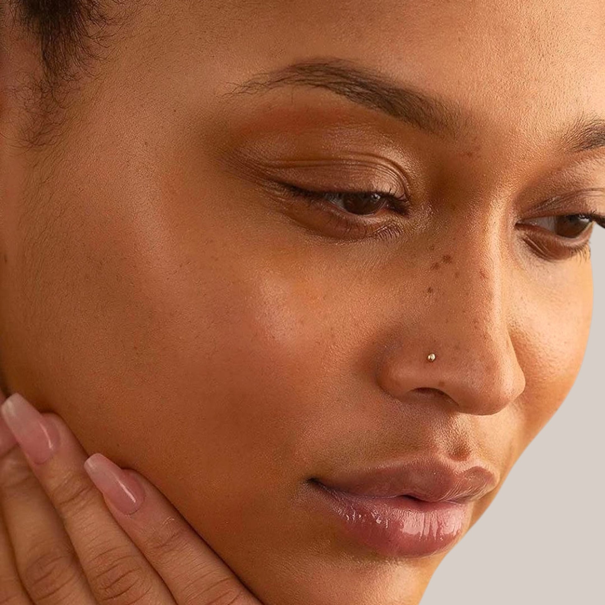 Close-up of a woman's face with a neutral background