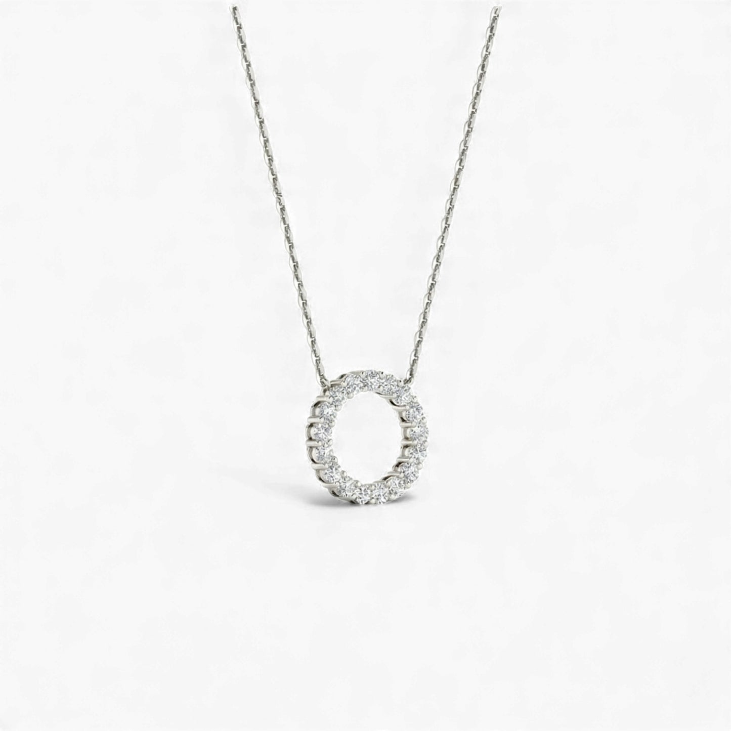 Silver necklace with a circular pendant on a white background