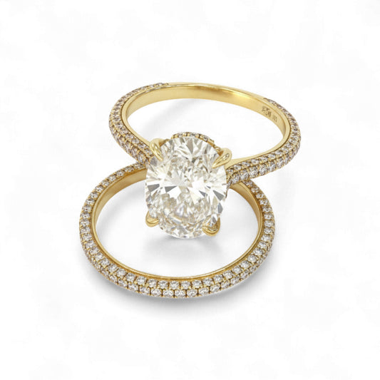 Gold ring with a large diamond and smaller diamonds on the band against a white background