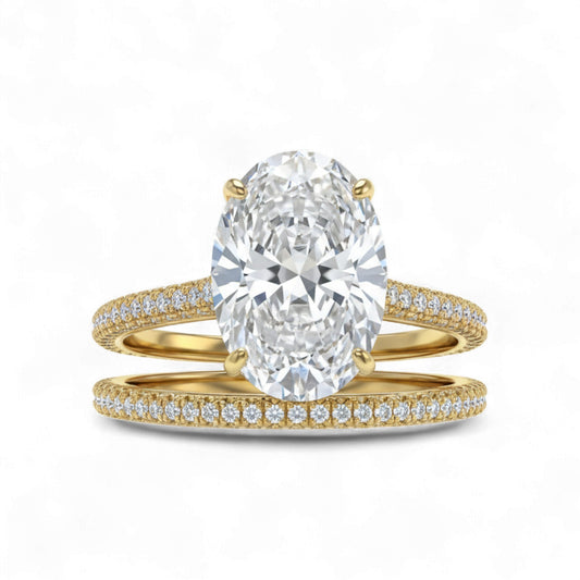 Gold ring with a large diamond and smaller diamonds on the band against a white background