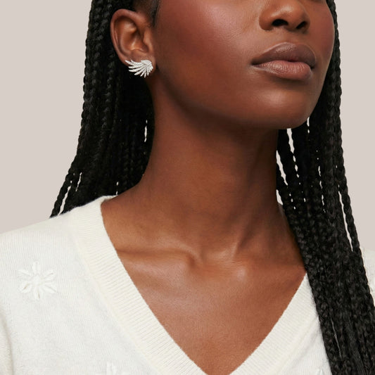 Woman wearing a white sweater with a neutral background