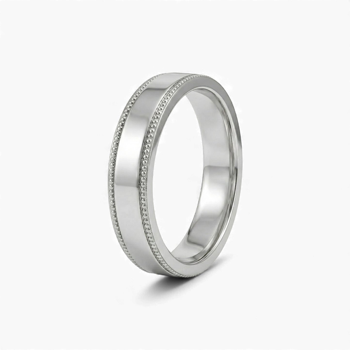 Silver ring with detailed design on a white background