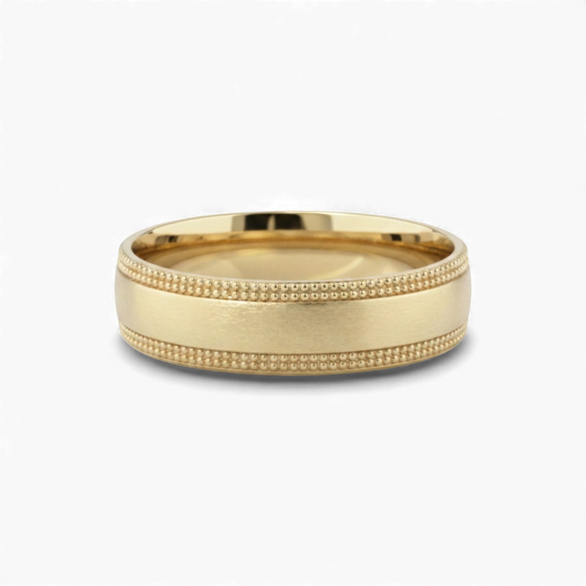 Gold ring with textured band on a white background