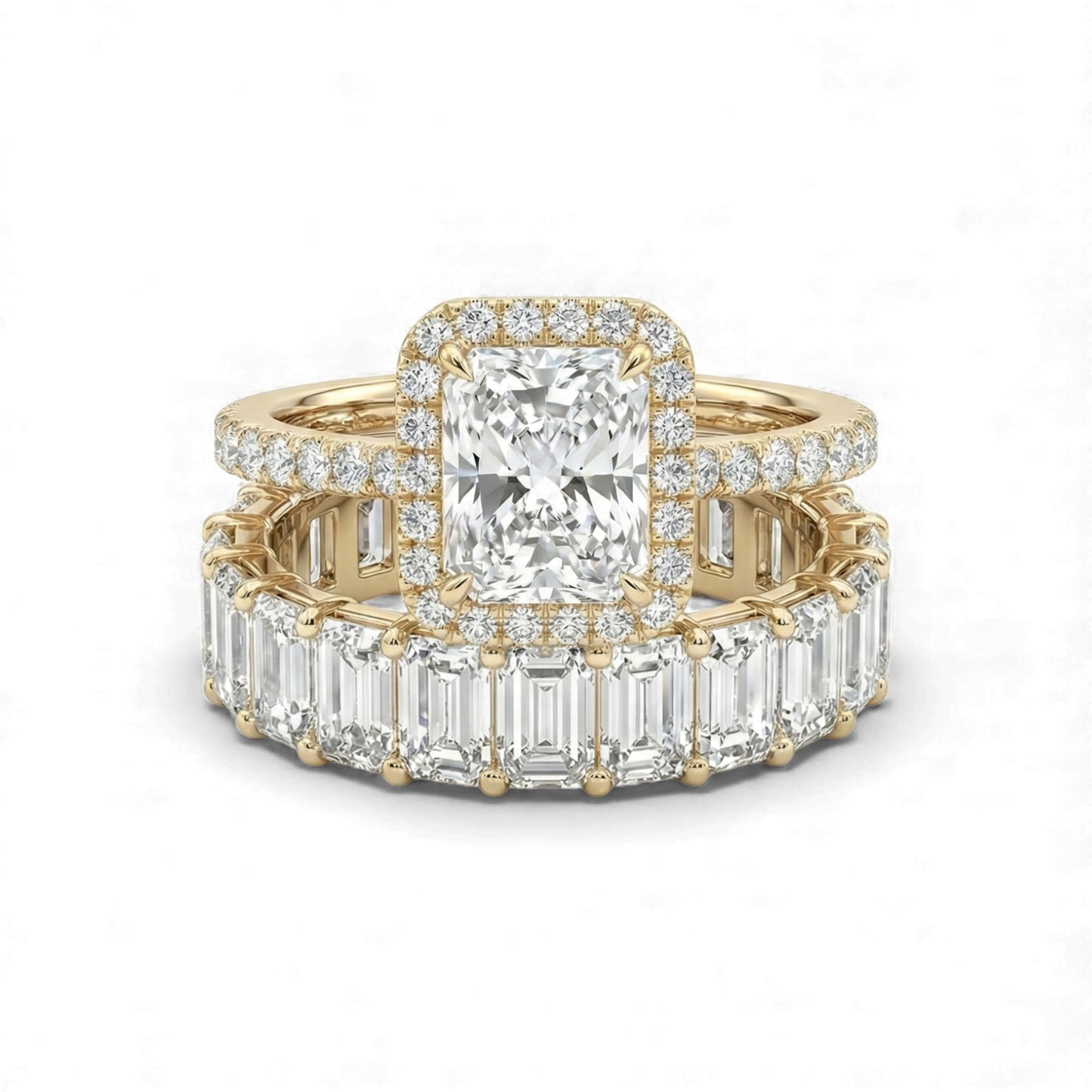 Gold ring with emerald-cut diamond and baguette diamonds on a white background