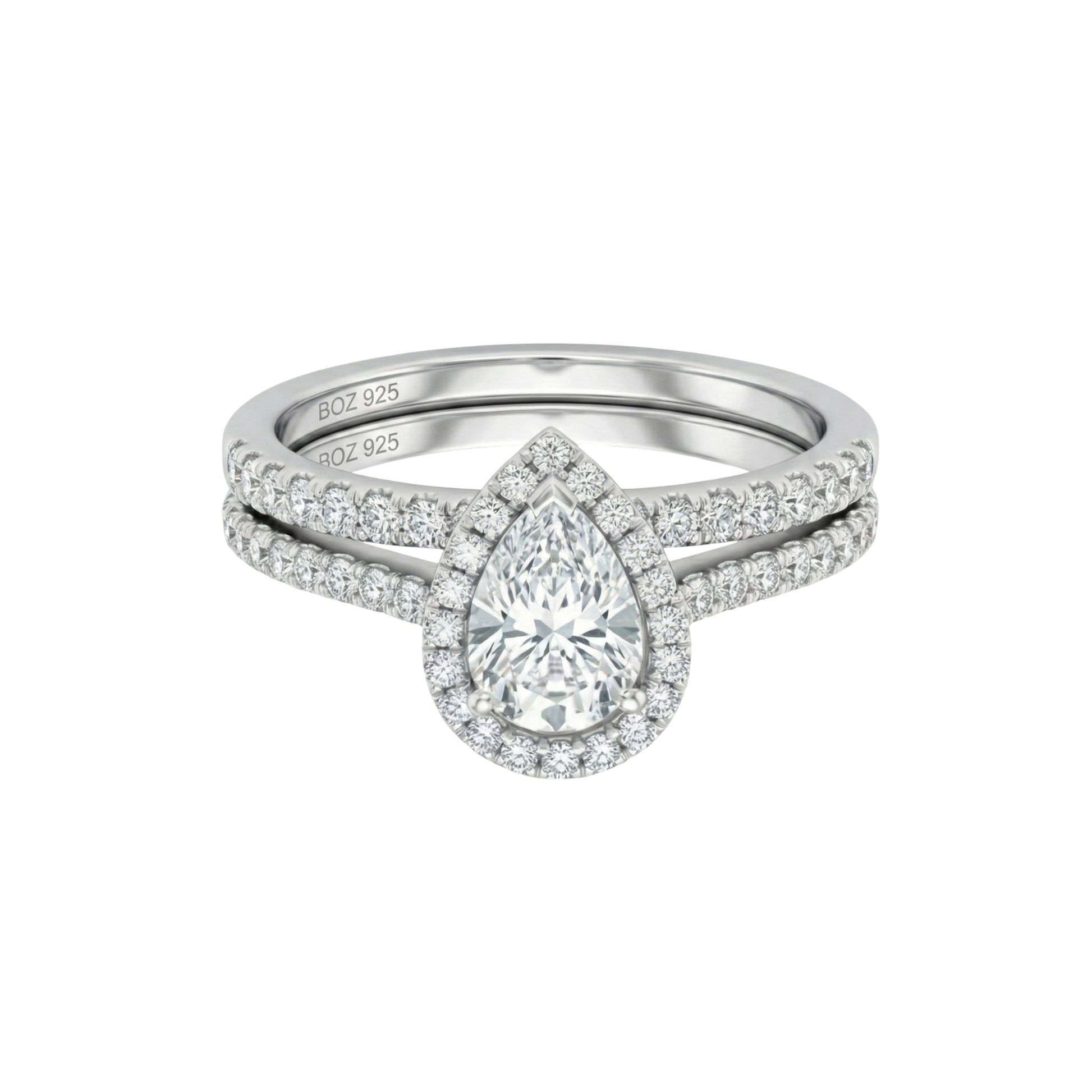 Diamond ring with a pear-shaped center stone on a white background