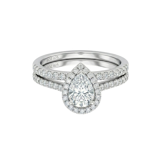 Diamond ring with a pear-shaped center stone on a white background