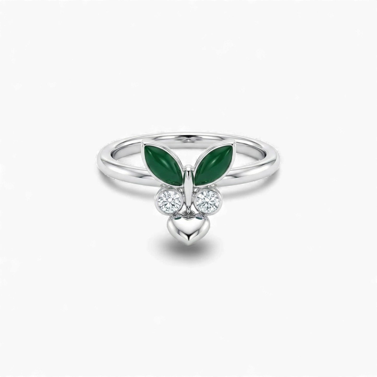 Silver ring with green gemstones and heart design on a white background