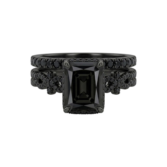 Black gemstone ring with intricate design on a white background
