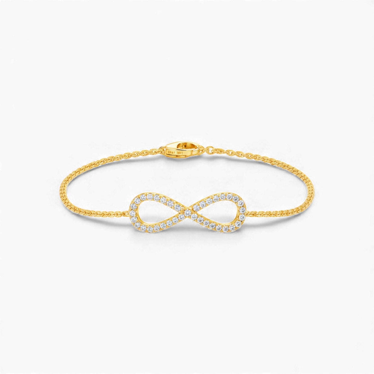Gold infinity bracelet on a white background