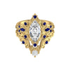 Gold ring with marquise-shaped diamond and blue gemstones on a white background
