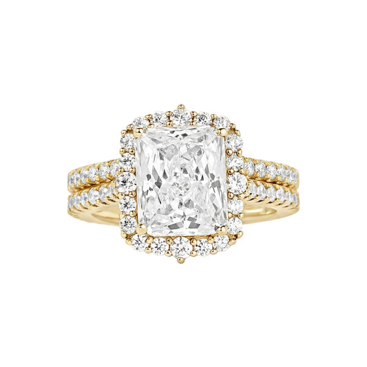 Gold ring with a large diamond and smaller diamonds on the band against a white background