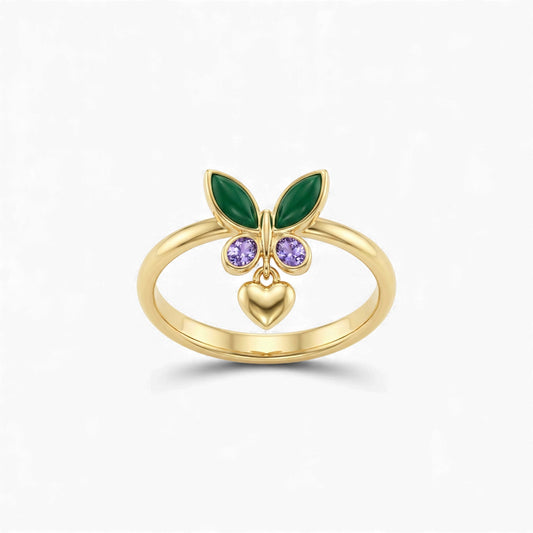 Gold ring with green leaves, purple gemstones, and a heart on a white background