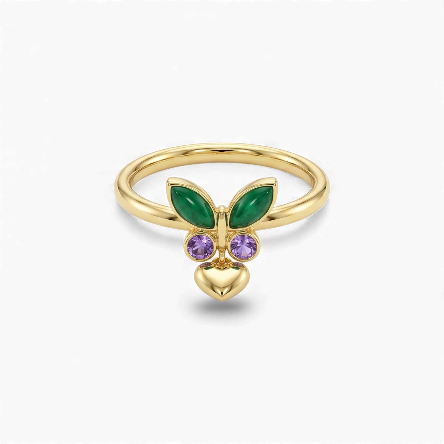 Gold ring with green and purple gemstones on a white background