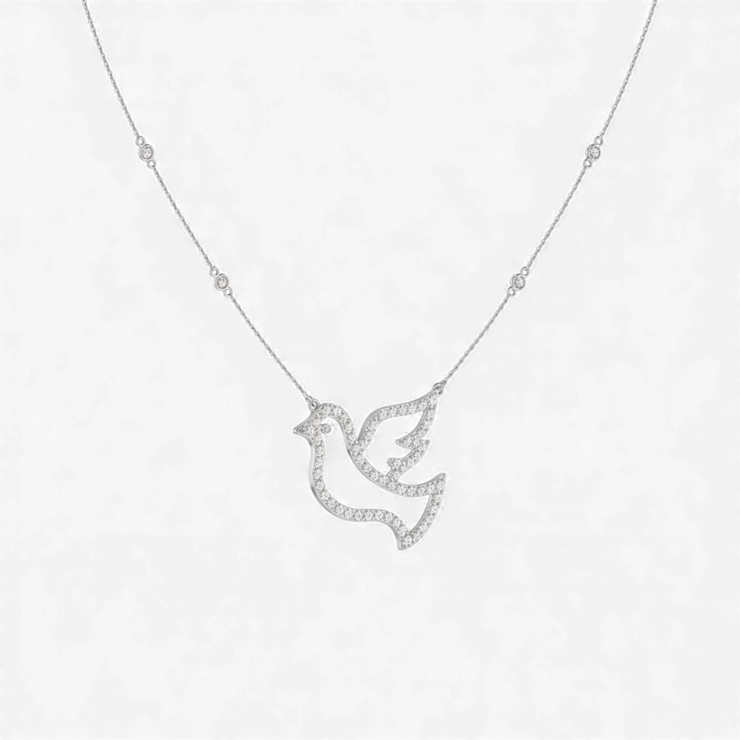Silver dove-shaped pendant necklace on a white background