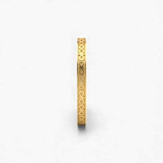 Gold bracelet with intricate design on a white background