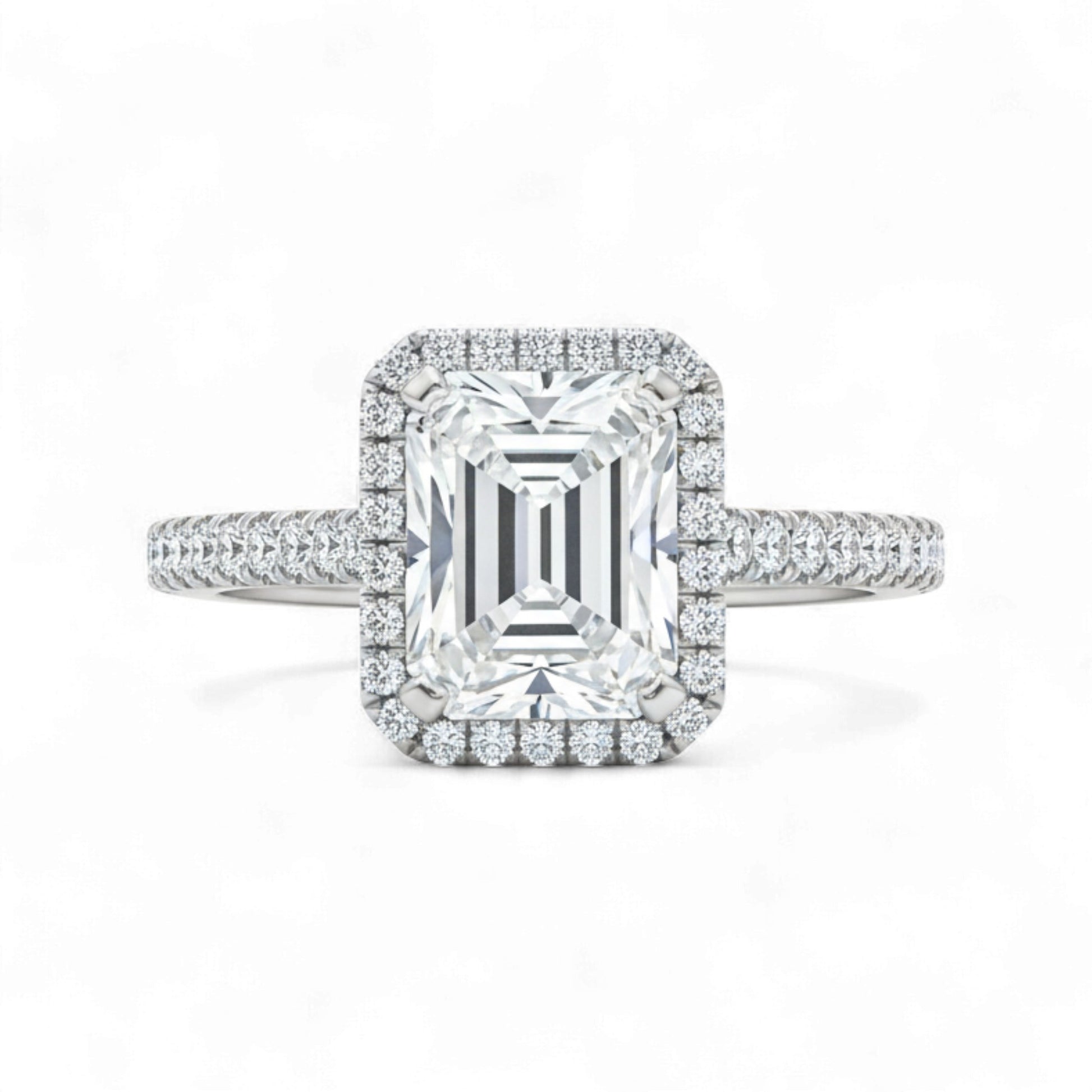 Diamond ring with emerald-cut center stone and halo on a white background