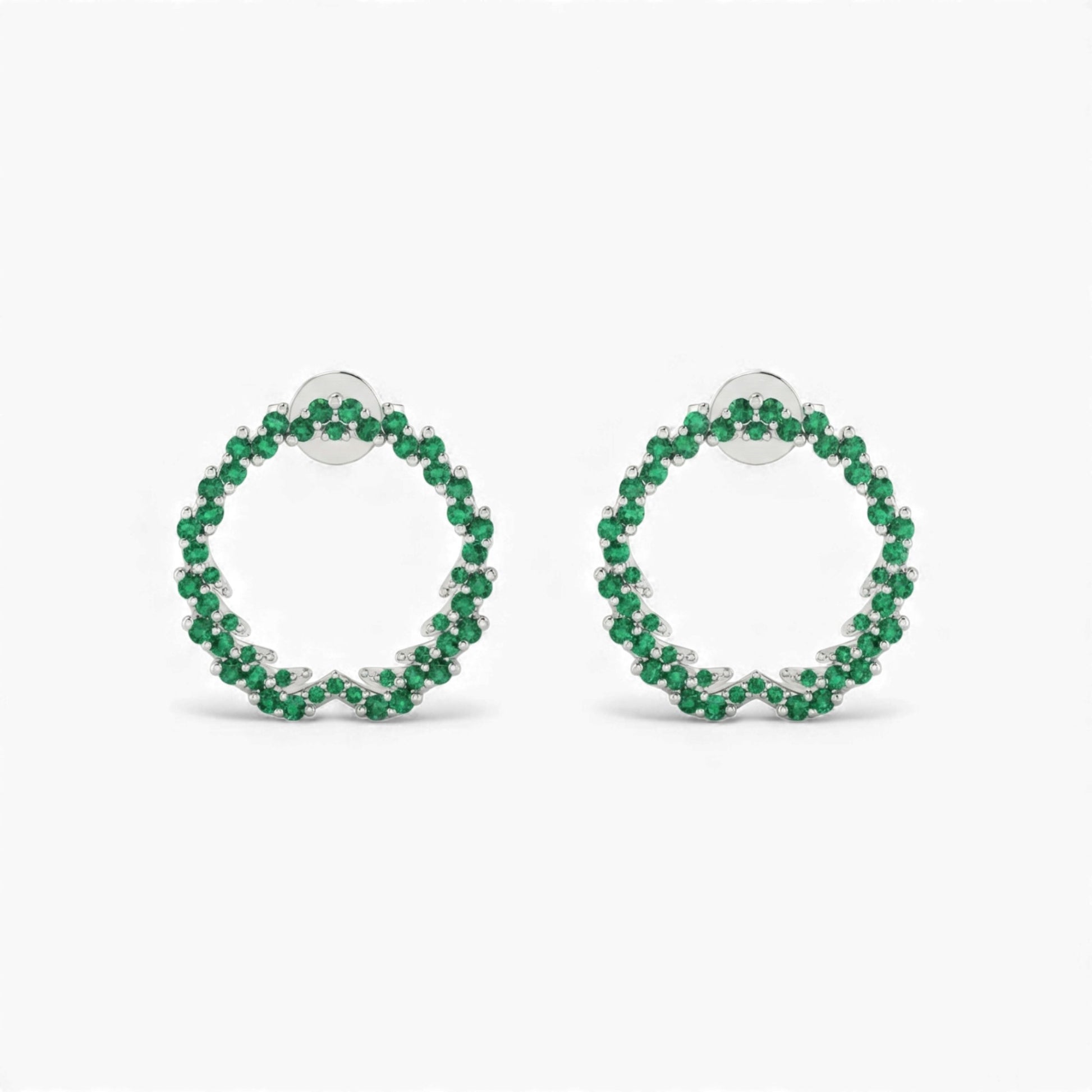 Pair of green hoop earrings on a white background