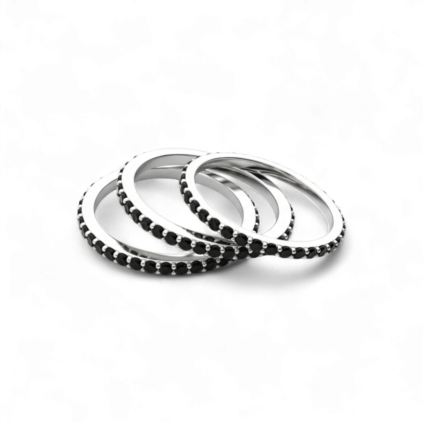 Set of silver and black beaded bracelets on a white background